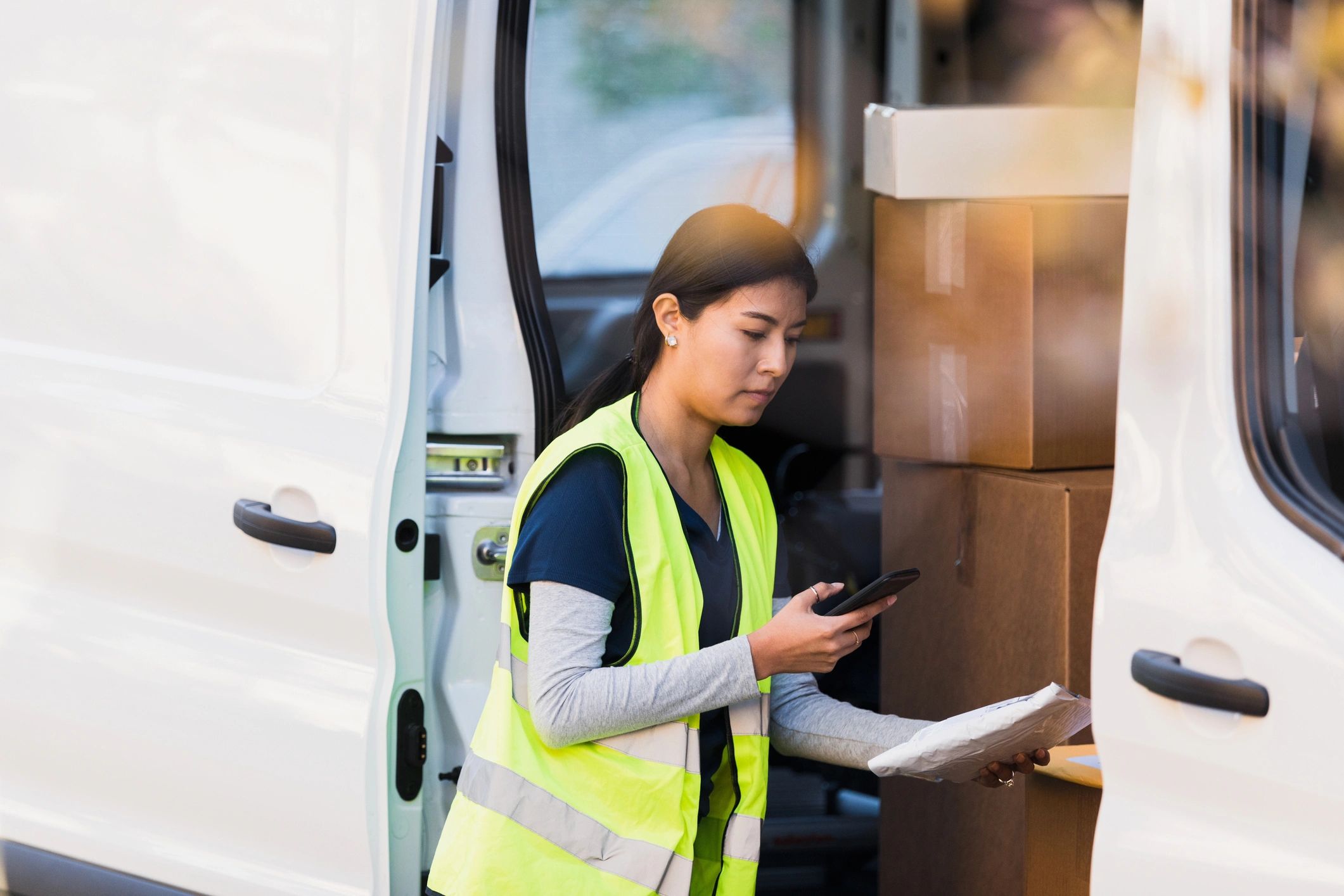 Delivery person scanning a package barcode for dispatch