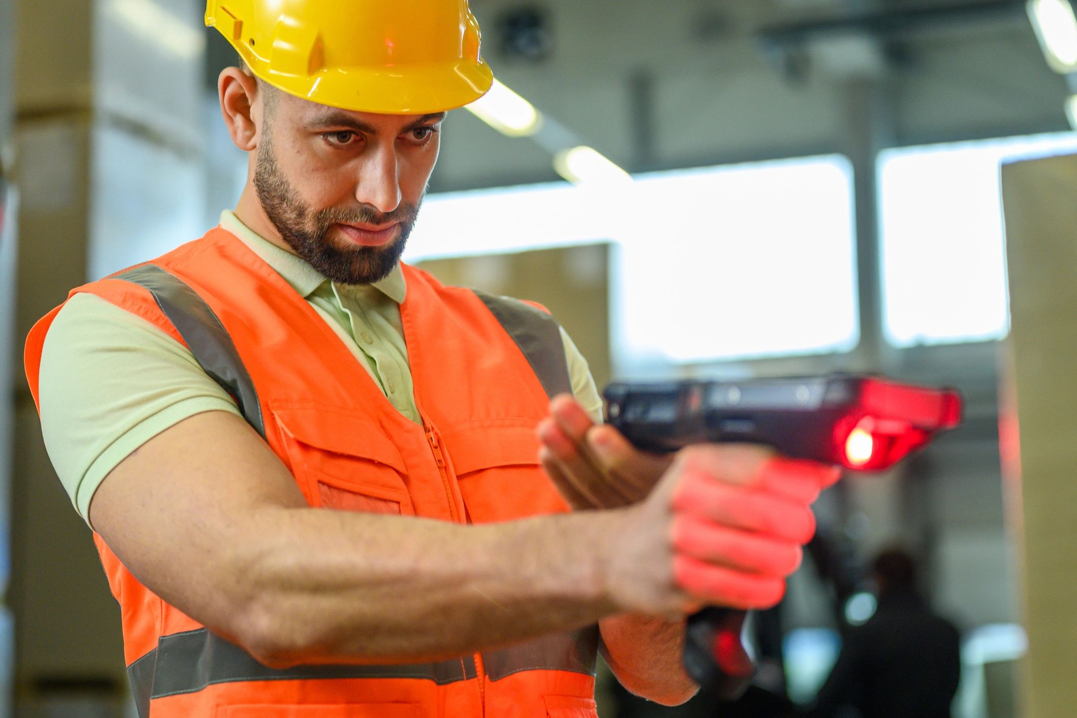Warehouse worker using a handheld scanner to manage inventory